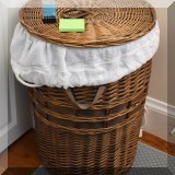 D078. Wicker hamper w/leather handles 24”h x 18”w - $18